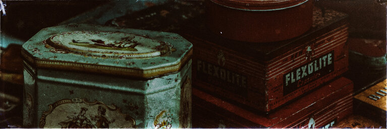 Collection of steel containers of mixed sizes, several of them a bit rusty