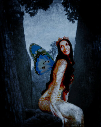 Larger than many of my other fairies, this winged and crowned woman is sitting on a tree branch and enjoying life.